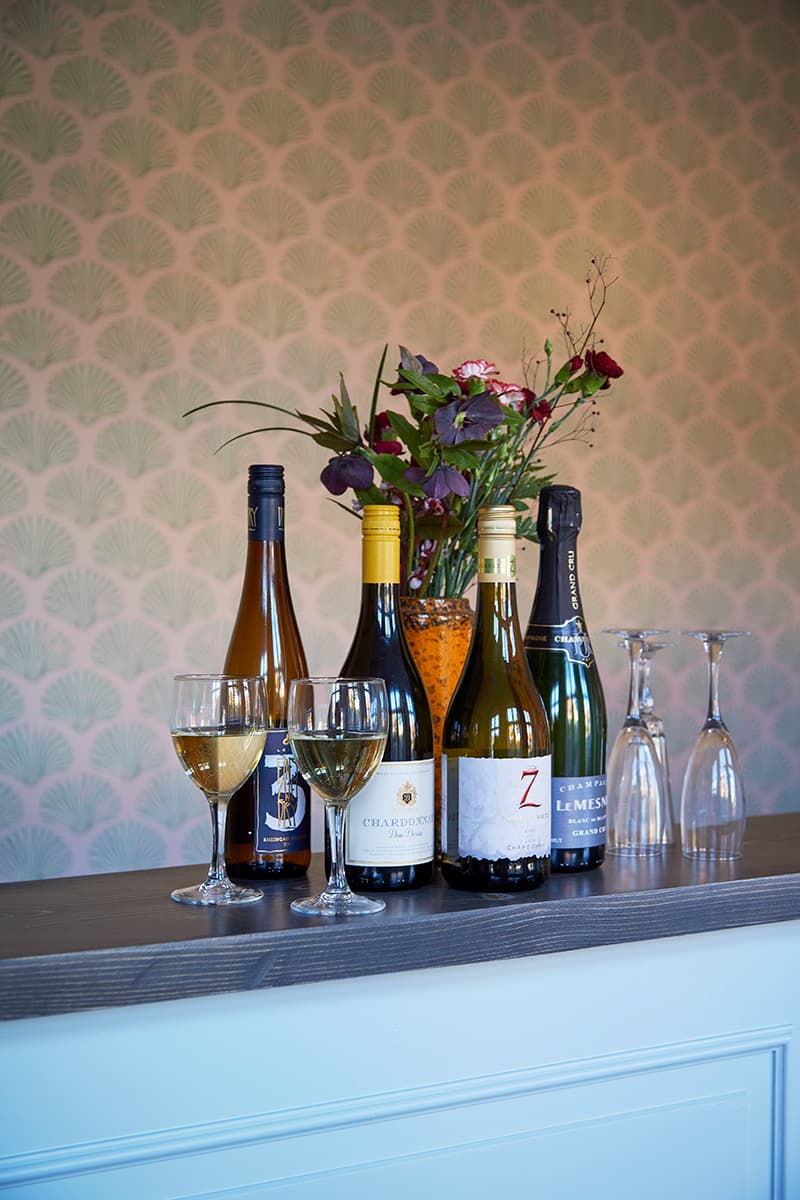 Wine glasses and flowers greets guest in the hotel bar