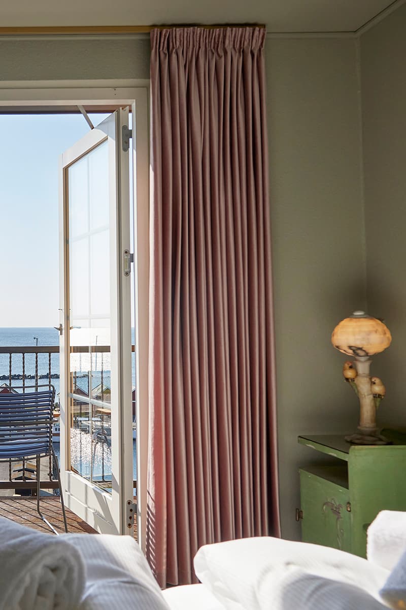 Double room at the hotel on Bornholm with sea view balcony bed and night table